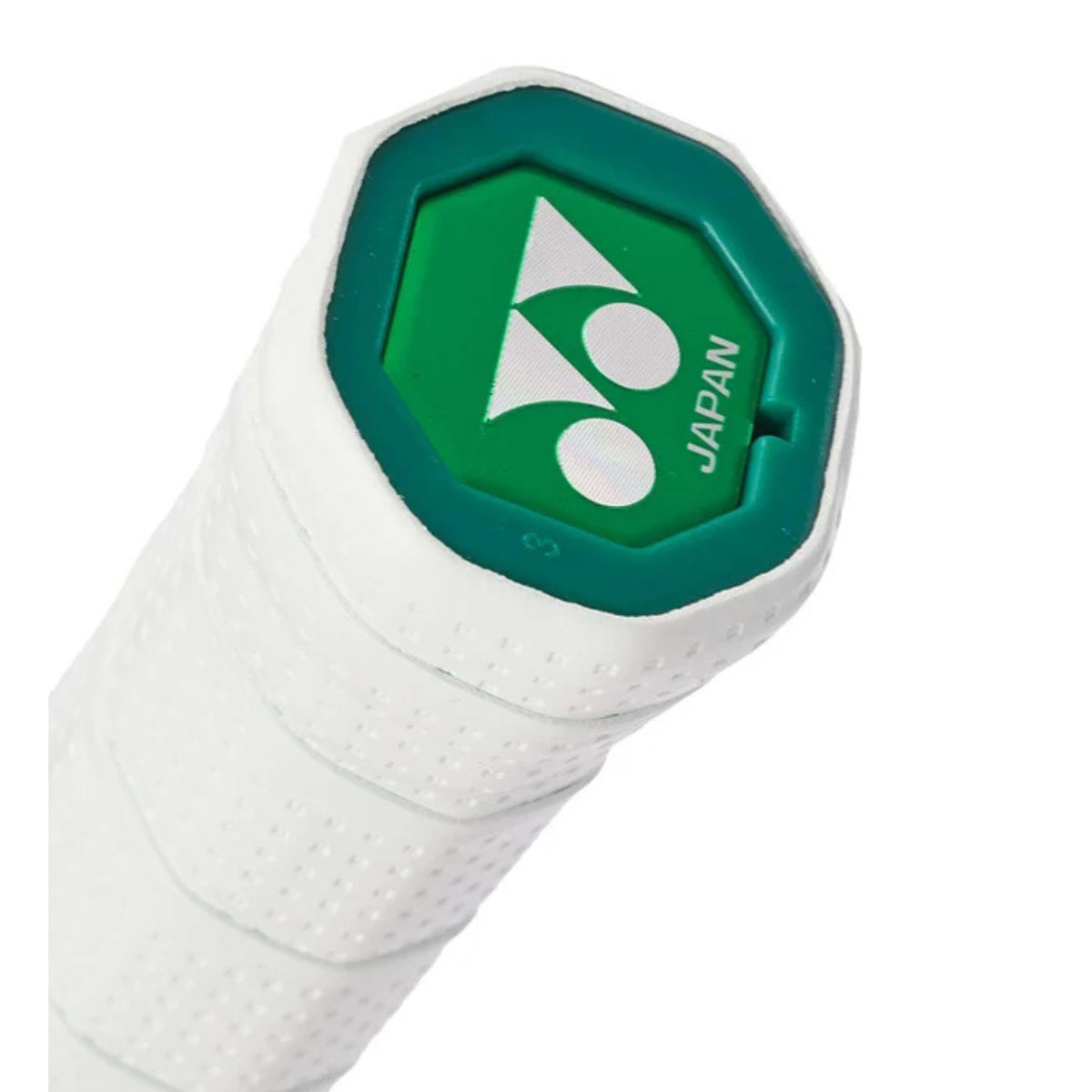 Close-up of a white tennis racket handle with green accent and 'Japan' text on a white background