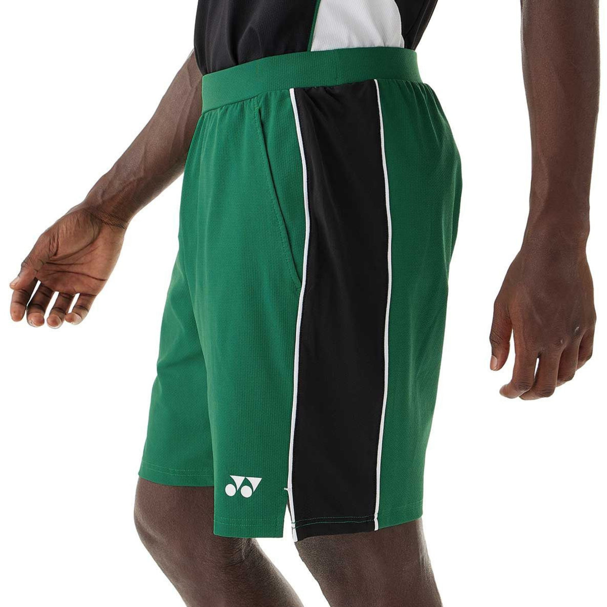 Green and black shorts with a visible brand logo on a white background