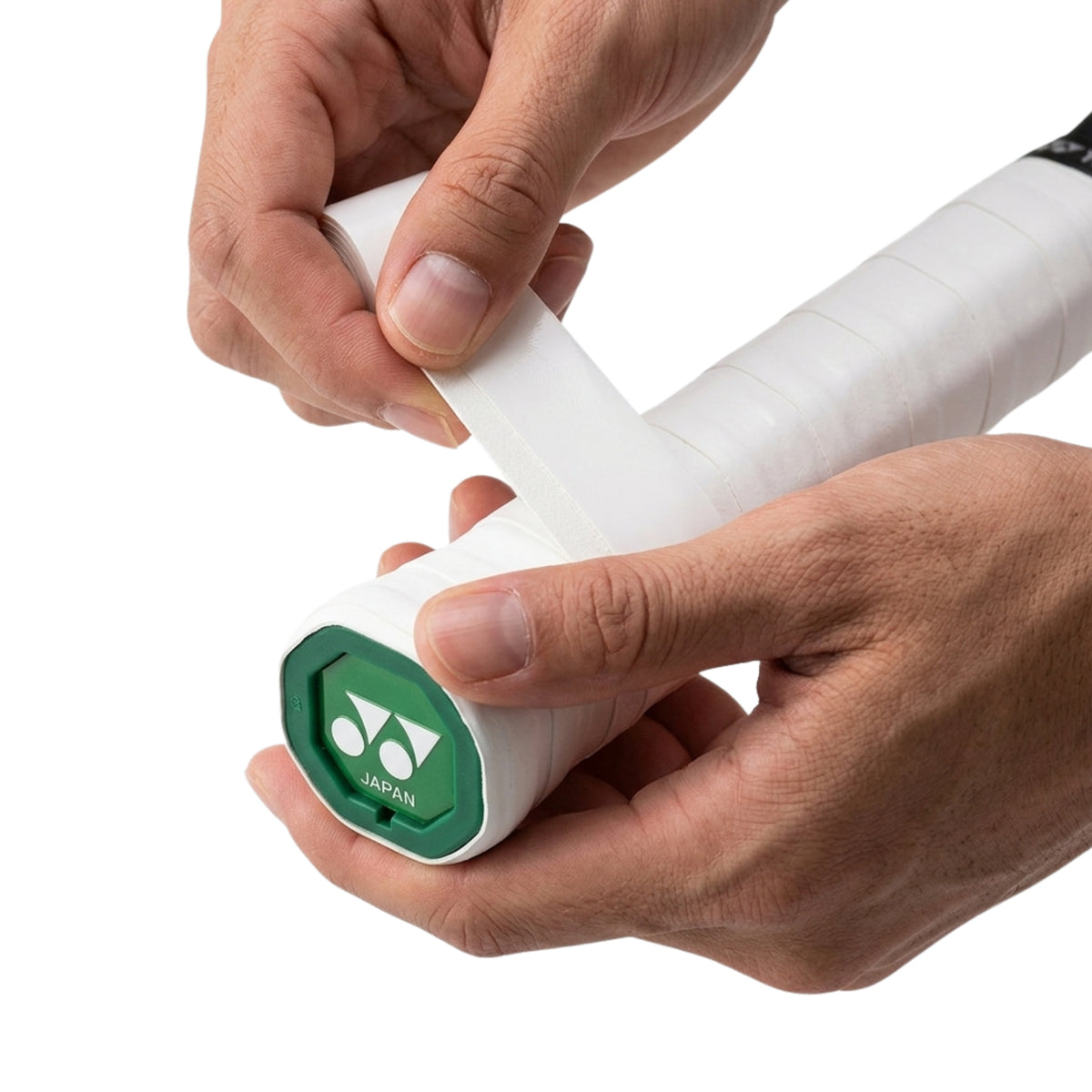 Person wrapping a white grip on a tennis racket handle on a white background