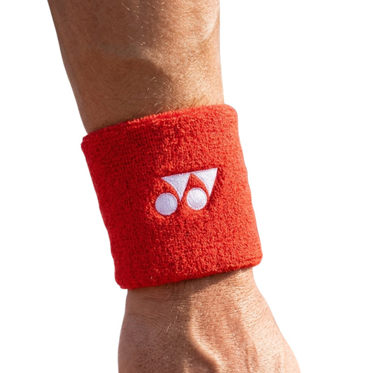 Red Yonex wristband worn by a person on a white background
