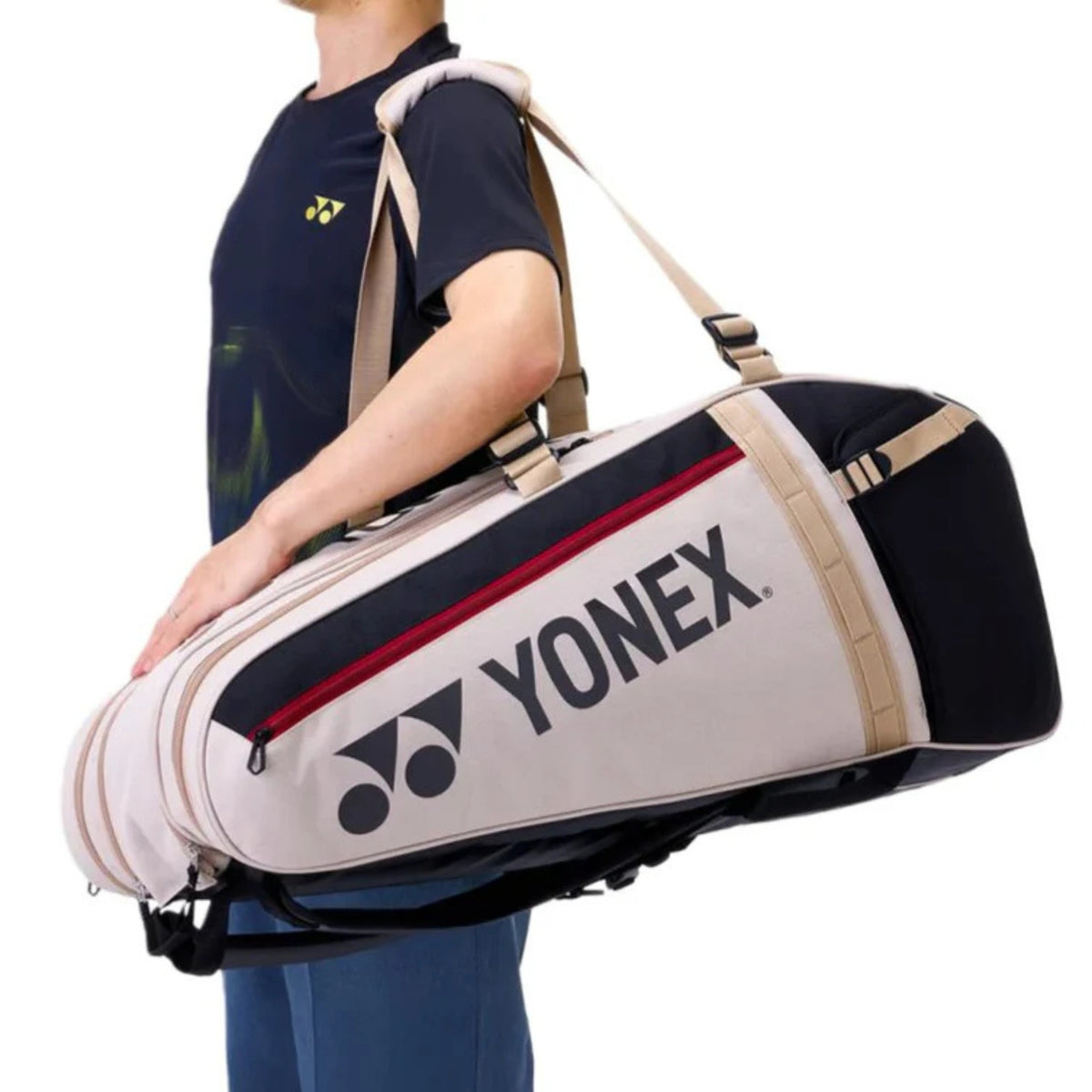 Person holding a Yonex racket bag on a white background