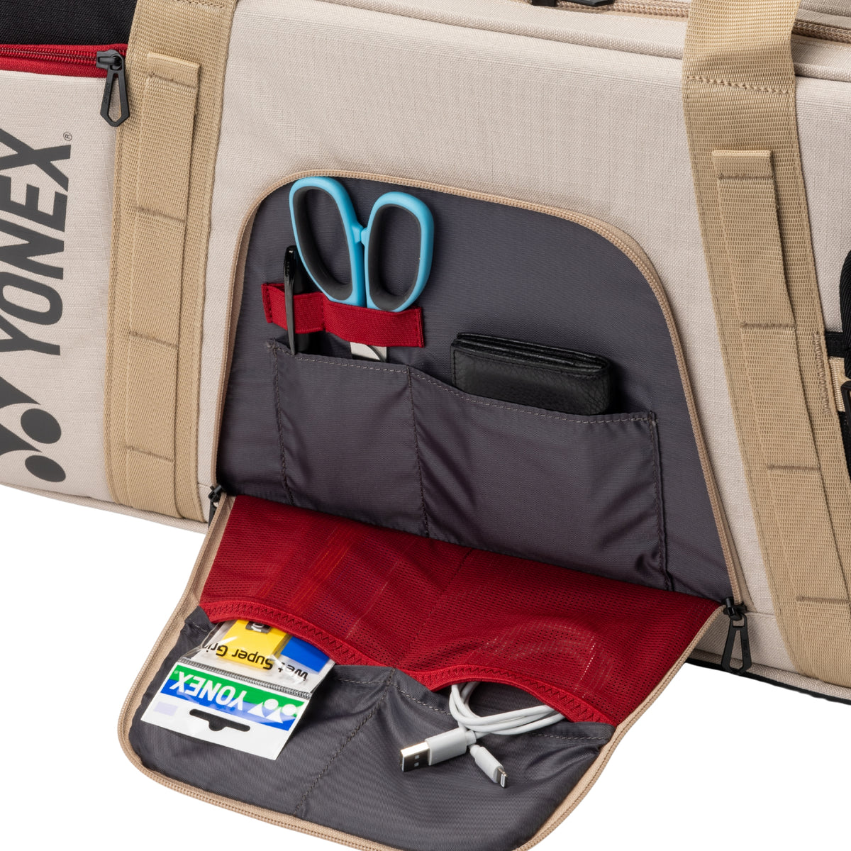Yonex bag with compartments containing office supplies on a white background