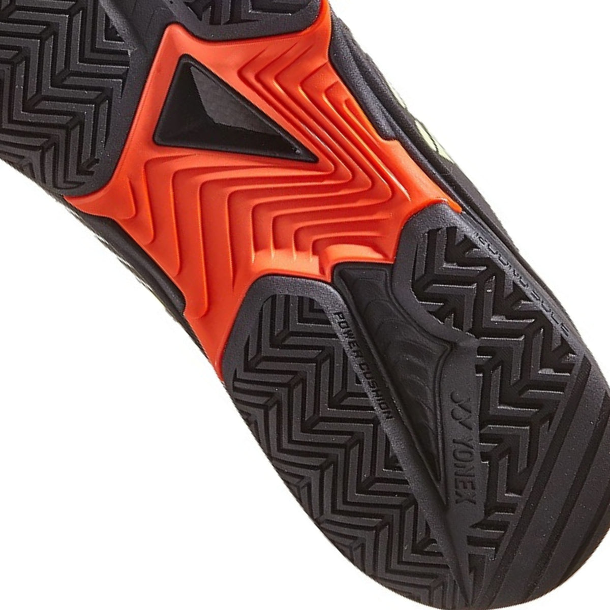 Close-up of a tennis shoe sole with orange and black pattern on a white background