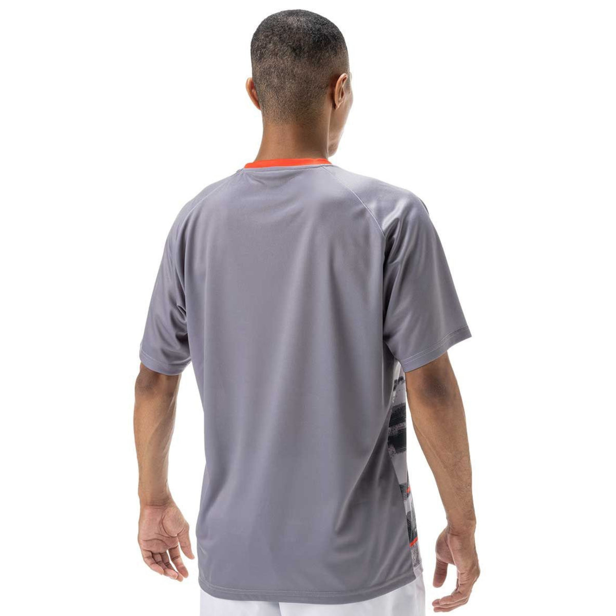 Person wearing a gray sports shirt on a white background