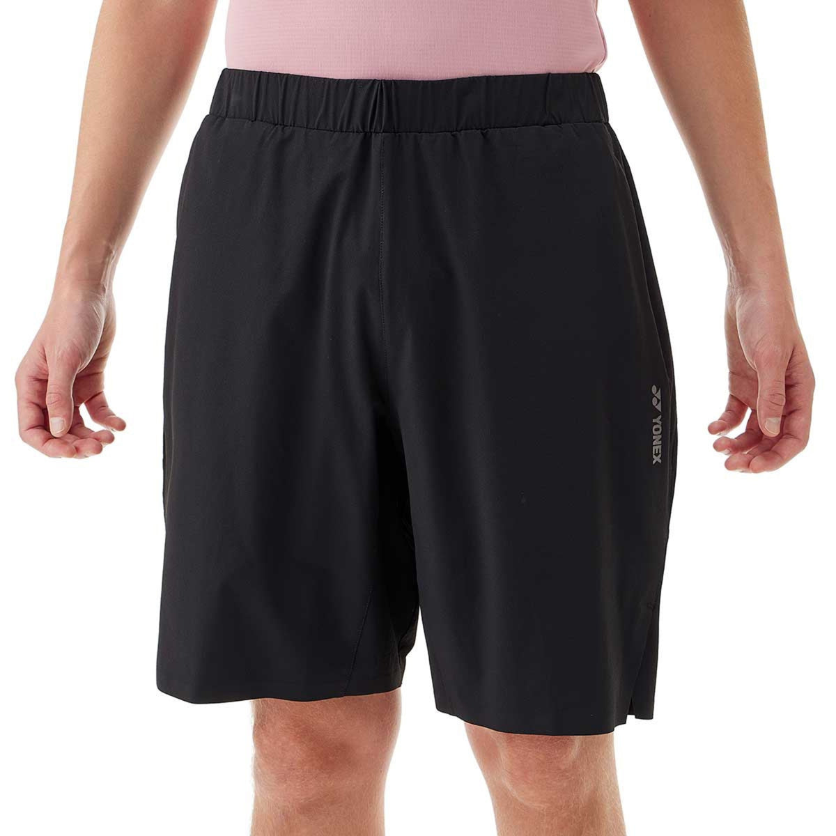 Black shorts worn by a person on a white background