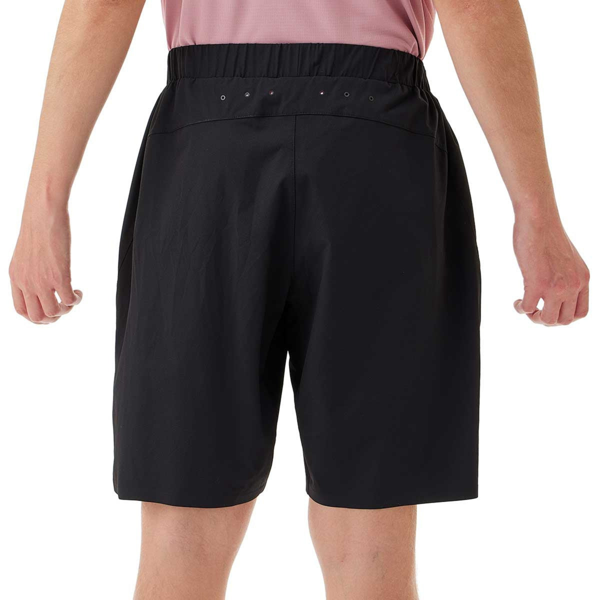 Black shorts worn by a person on a white background