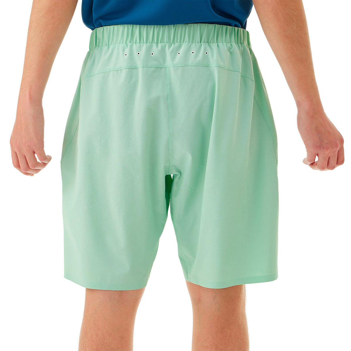 Light green shorts worn by a person on a white background