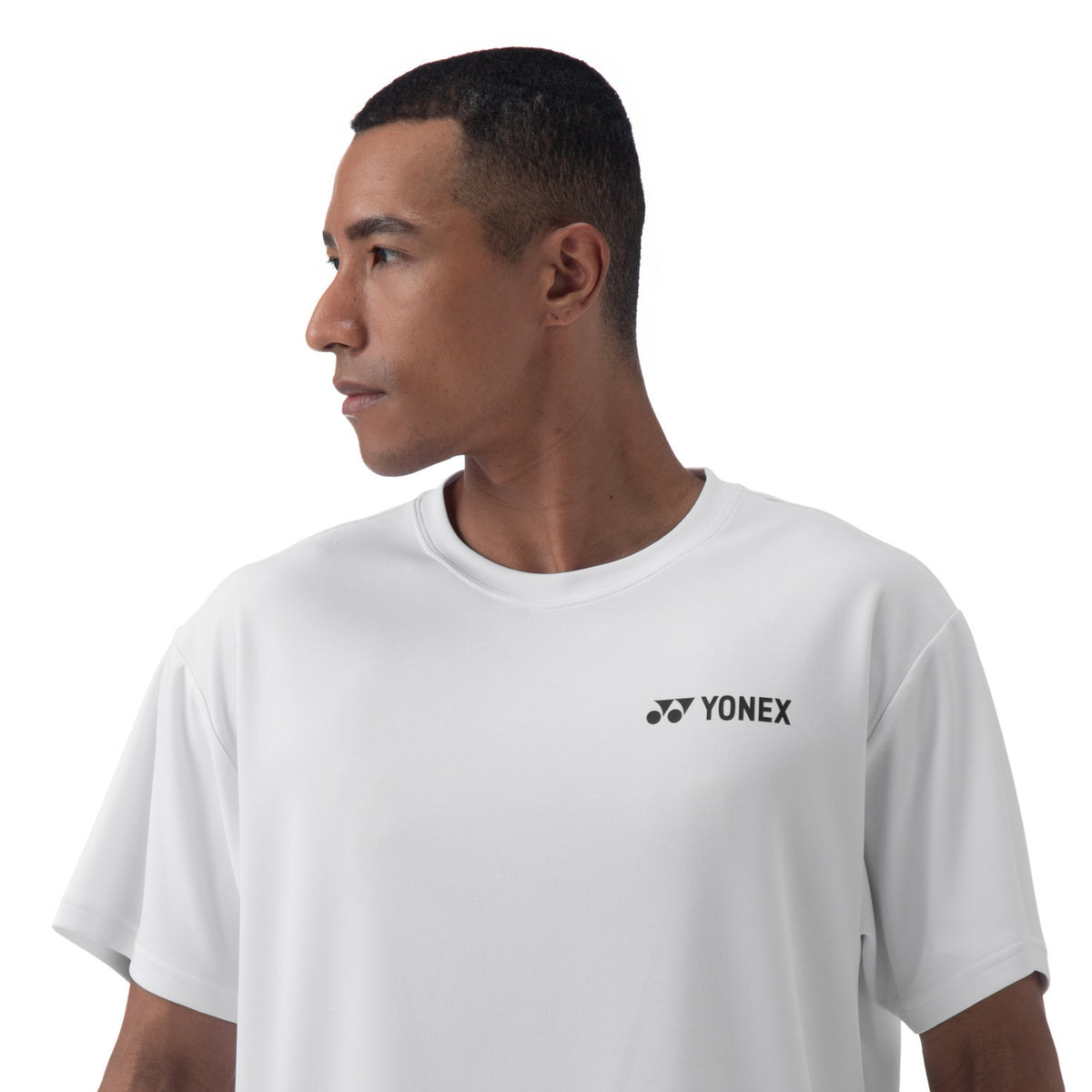 Man wearing a white Yonex t-shirt on a white background