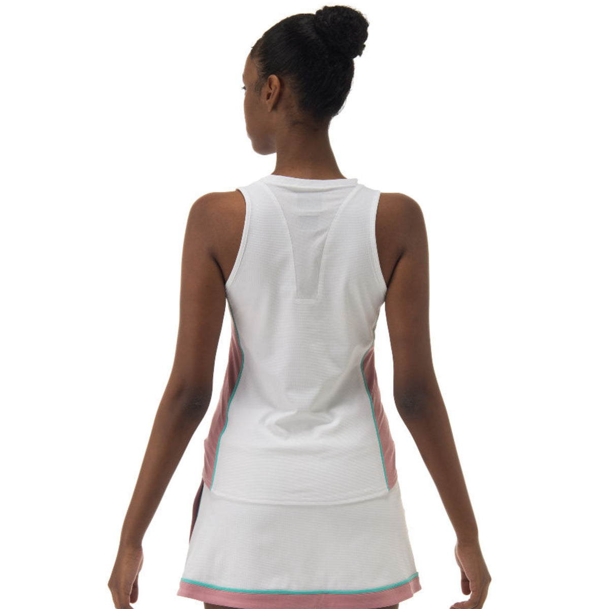 Woman wearing a white tennis dress with pink accents on a white background