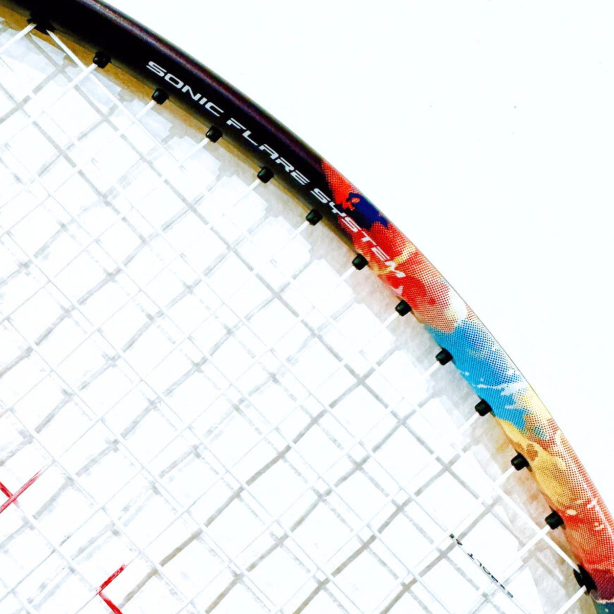 Close-up of a badminton racket with 'Sonic Flare' branding on a white background