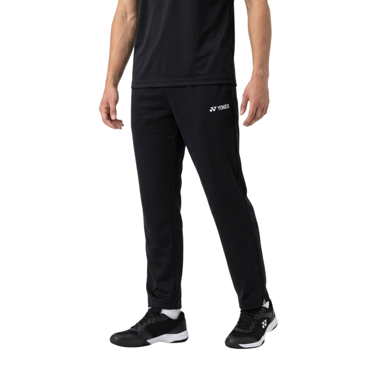 Person wearing black Yonex athletic pants on a white background