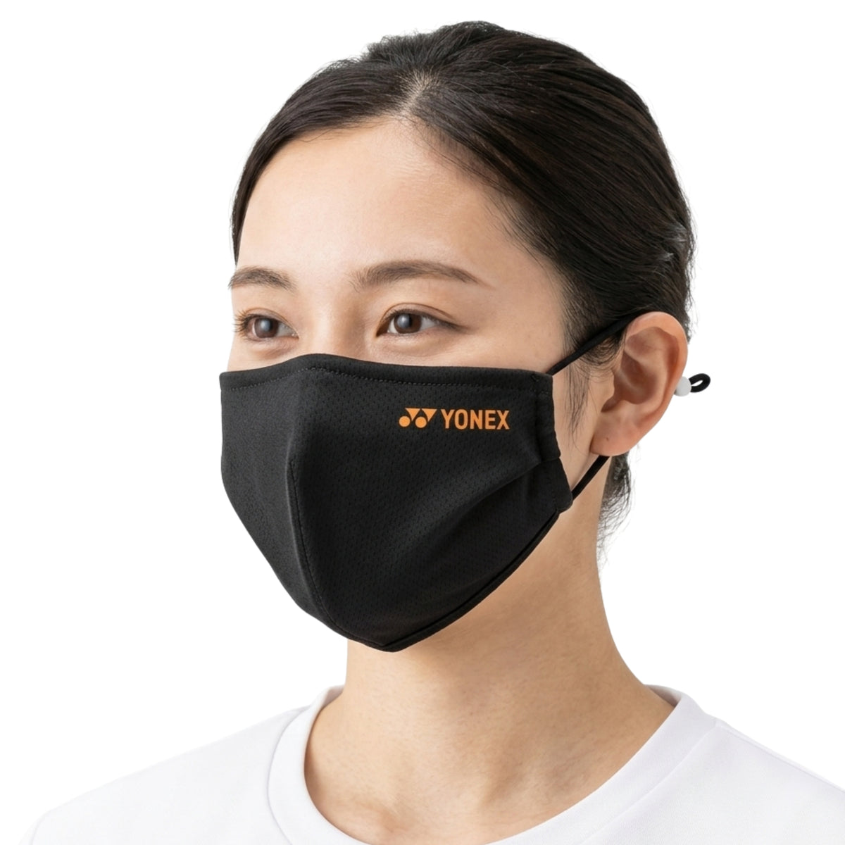 Person wearing a black Yonex face mask on a white background