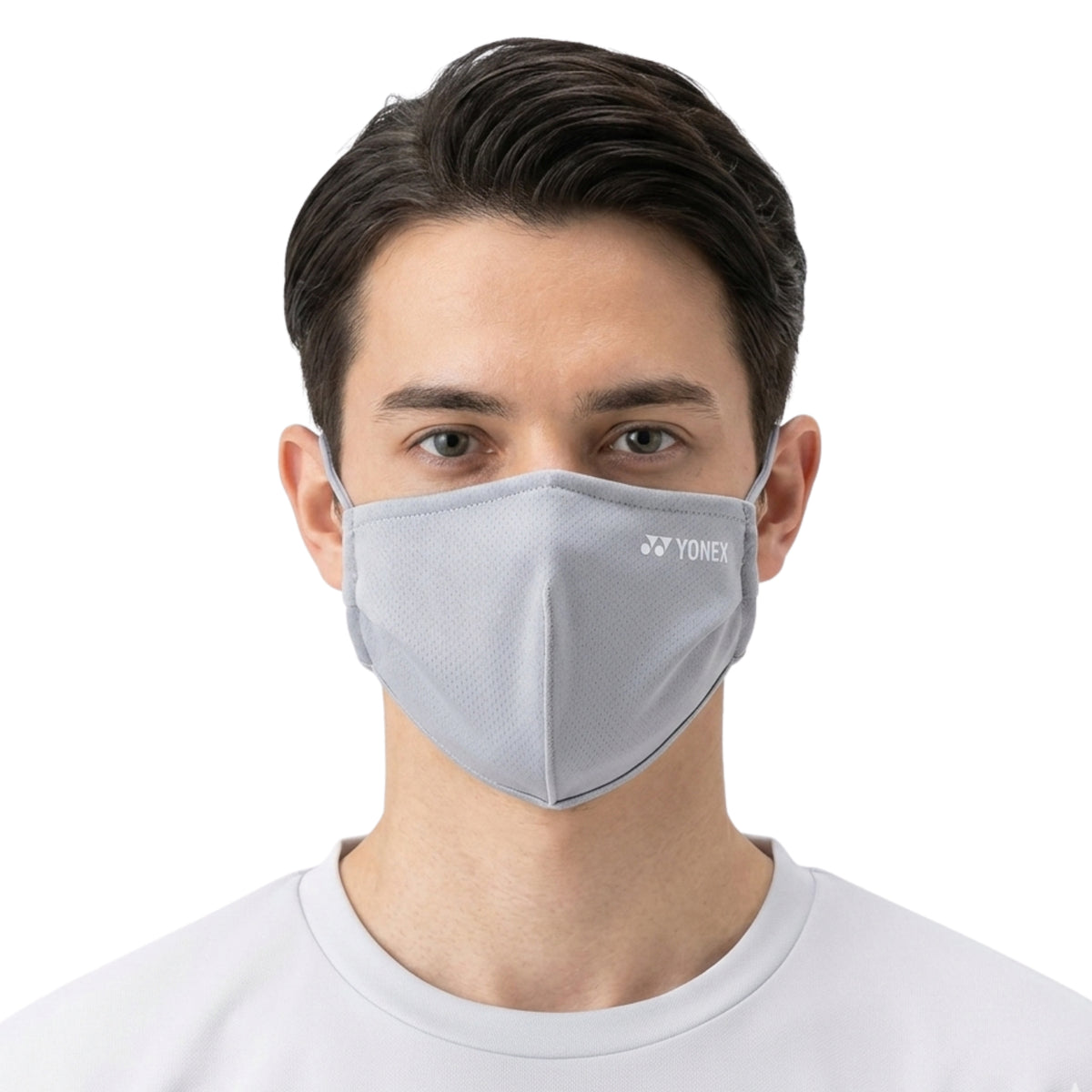 Person wearing a gray face mask with Yonex logo on a white background