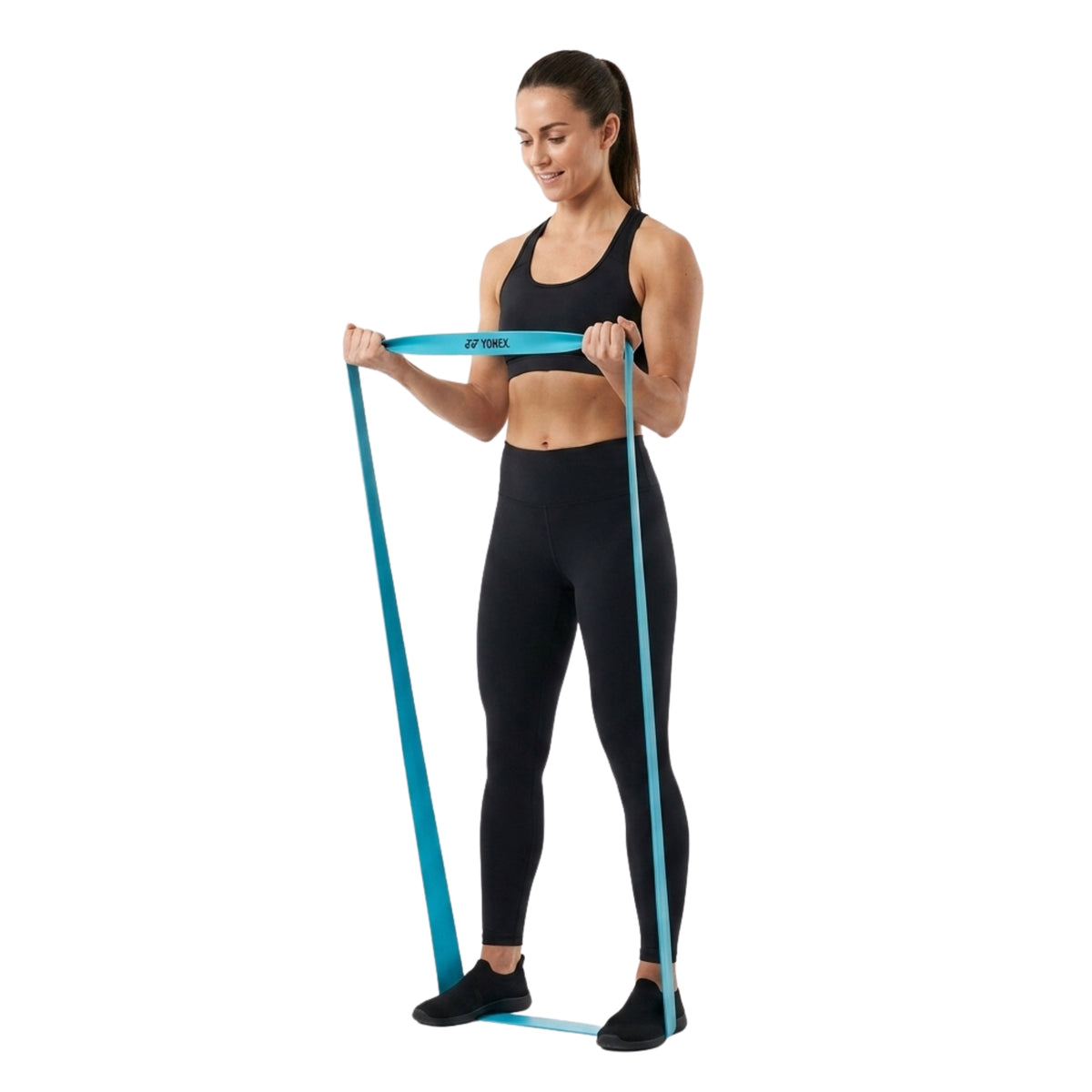 Woman exercising with a resistance band on a white background