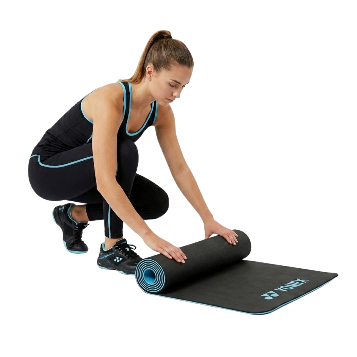 Person rolling up a Yonex yoga mat