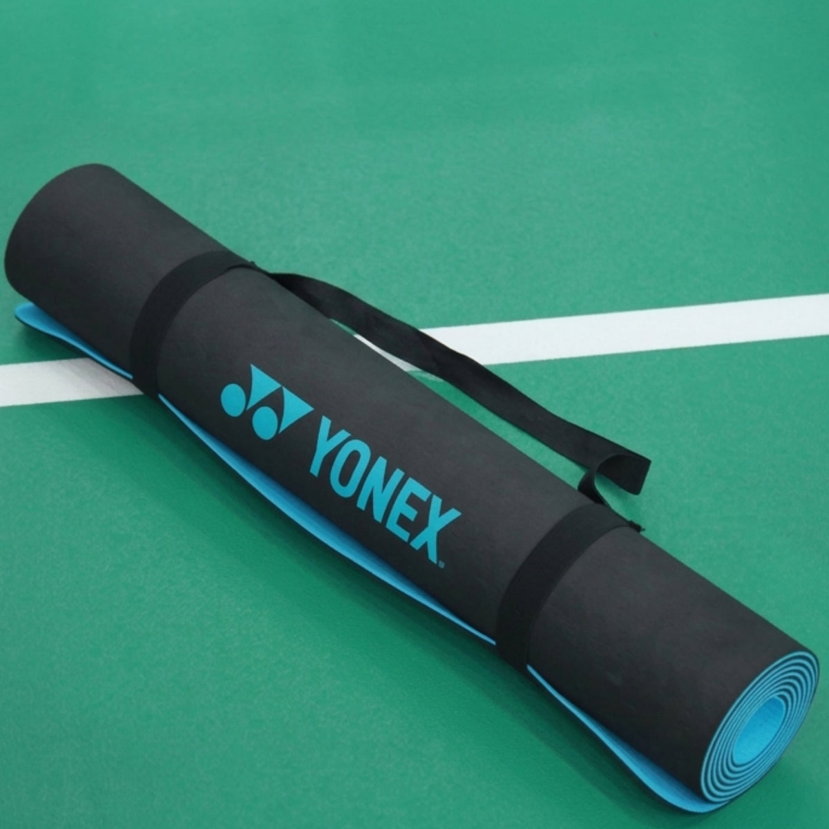 Yonex mat on a green surface