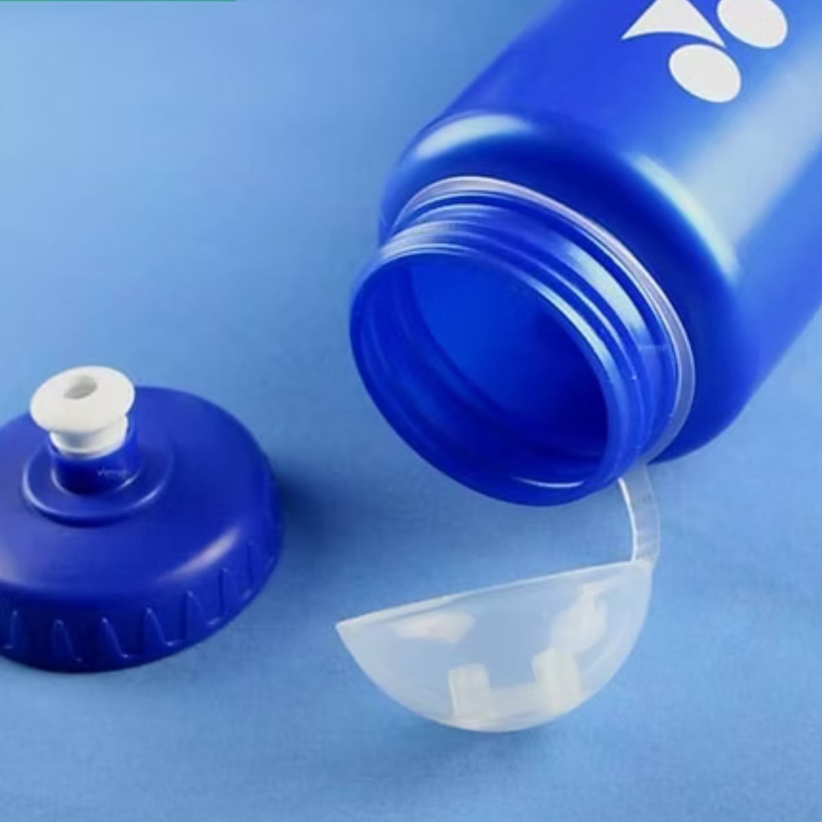 Blue water bottle with a clear cap on a blue background