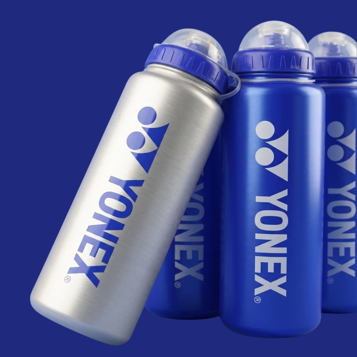 Yonex water bottles in silver and blue on a dark blue background
