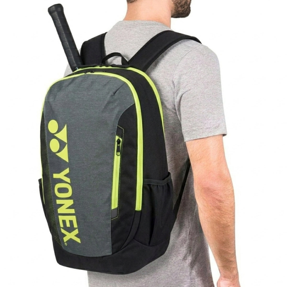 Person wearing a Yonex backpack with a tennis racket on a white background