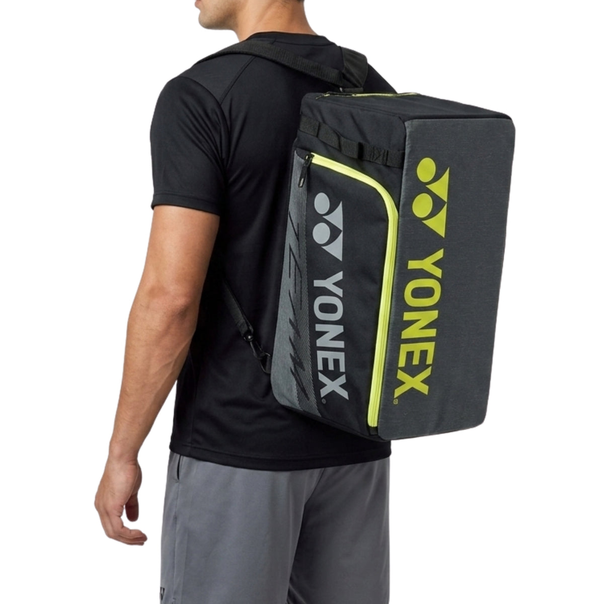 Person wearing a Yonex backpack on a white background
