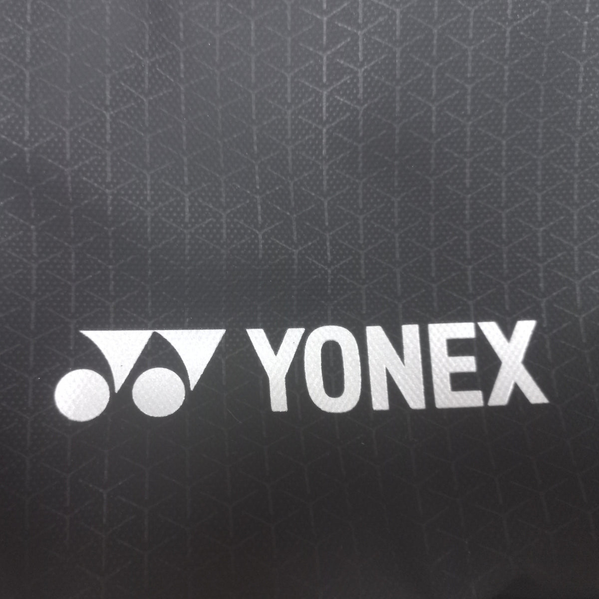 Yonex logo on a black shoulder bag background