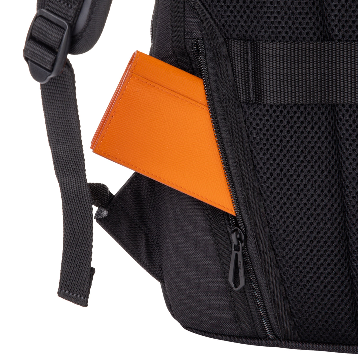 Black backpack with an orange card in a pocket on a white background