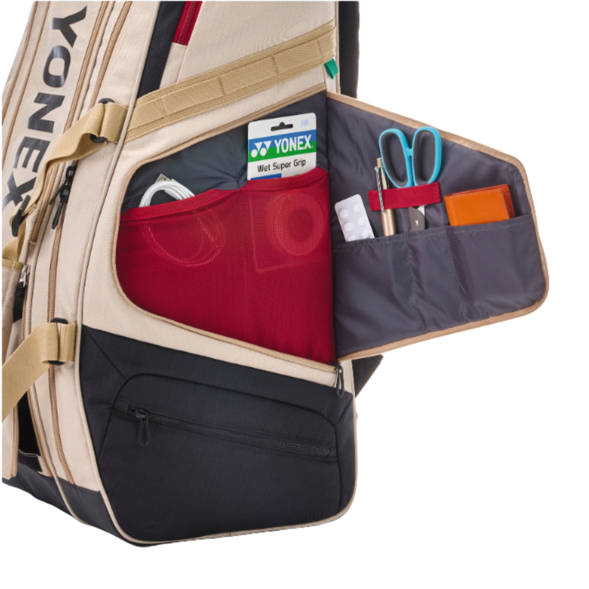Open racket bag with Yonex branding and various items inside on a white background