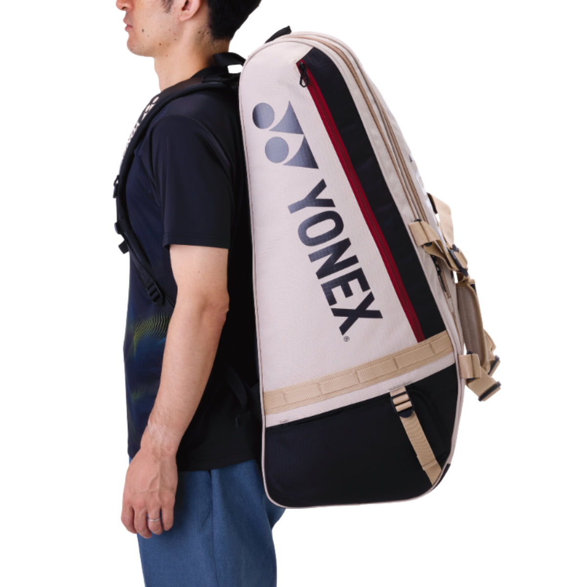 Person carrying a Yonex racket bag bag on their back against a white background