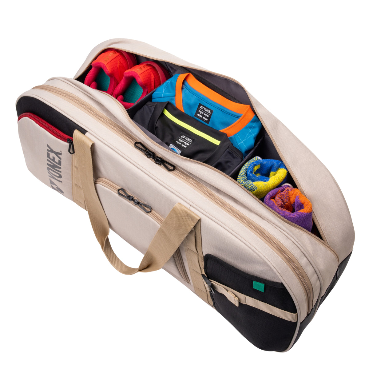 Beige travel bag with colorful clothing items on a white background
