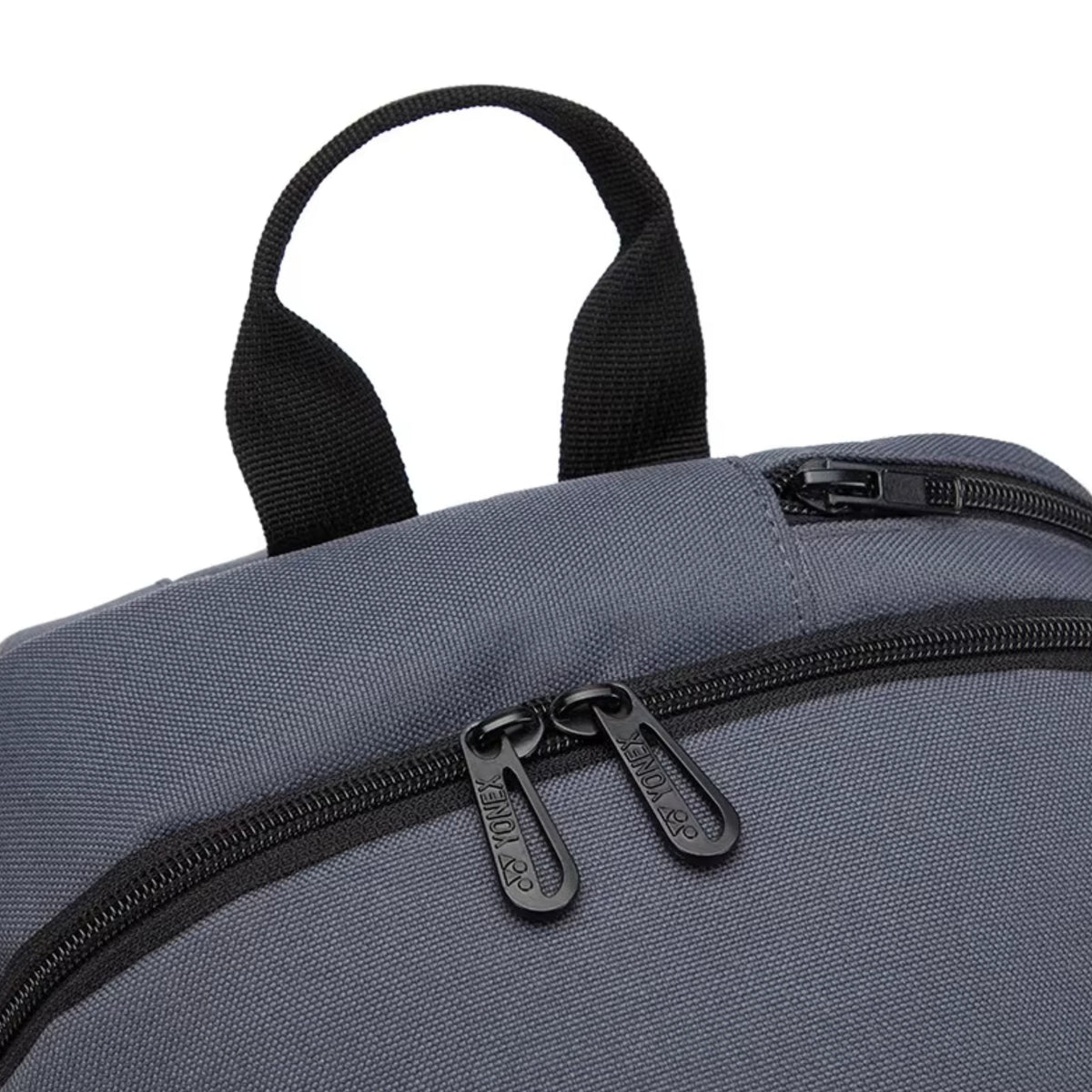 Gray backpack with black zippers and handles on a white background