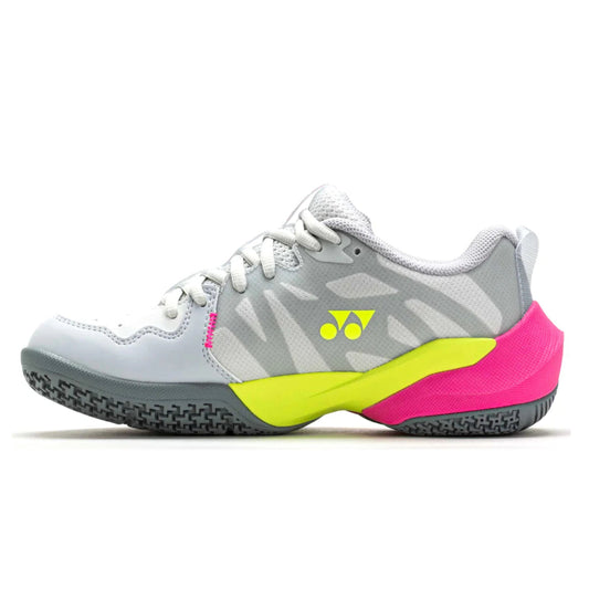 Gray and pink Yonex tennis shoe with yellow accents on a white background