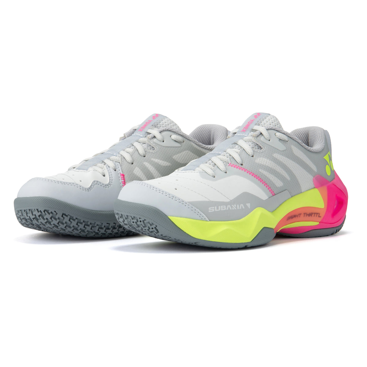 Pair of gray and pink Yonex tennis shoes with green accents on a white background