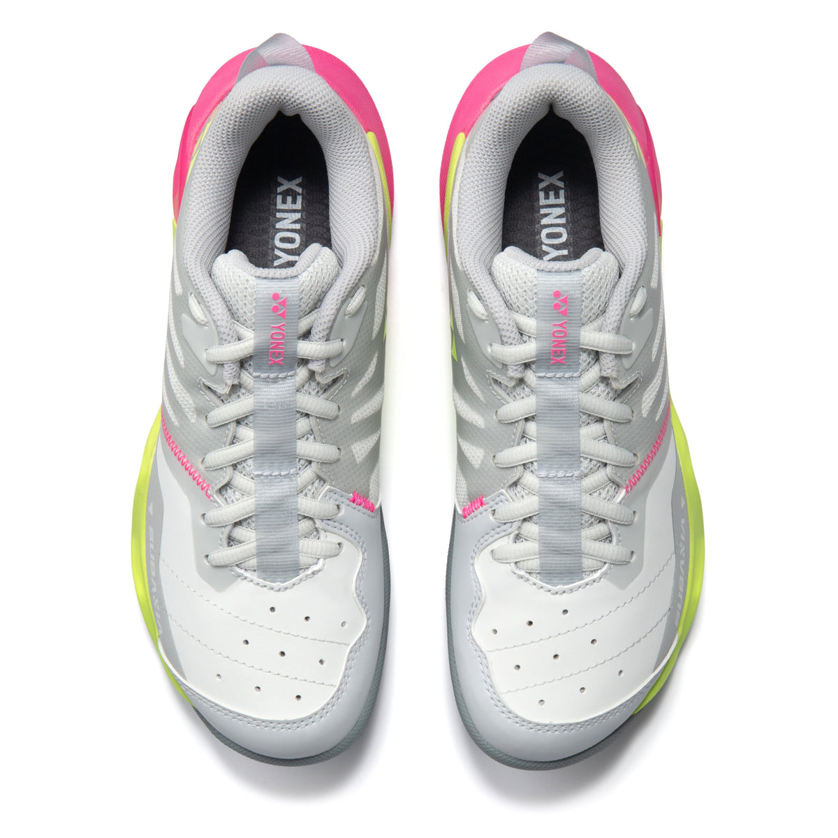 White and pink Yonex tennis shoes on a white background