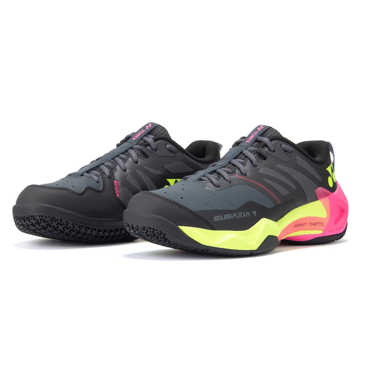 Pair of black and pink Yonex tennis shoes with yellow accents on a white background