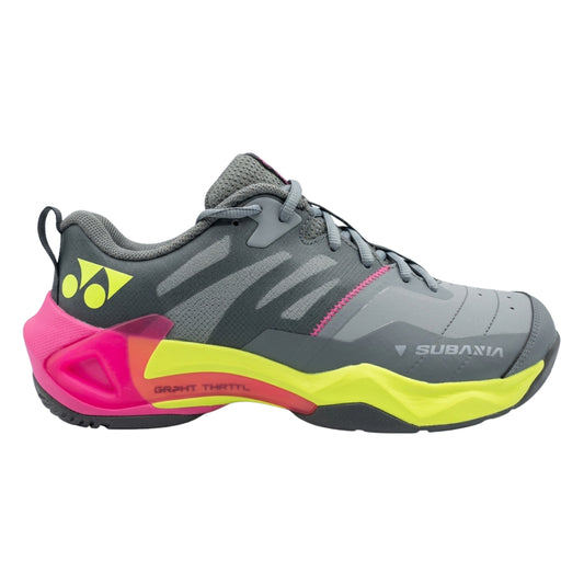 Gray Yonex tennis shoe with pink and yellow sole on a white background