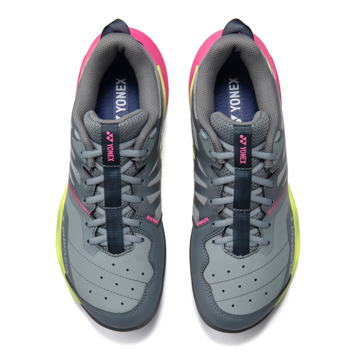Gray Yonex tennis shoes with pink and yellow accents on a white background