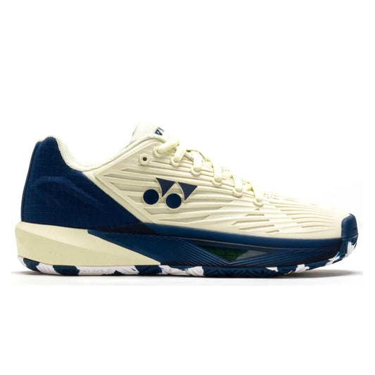 Blue and white Yonex tennis shoe with brand logo on a white background