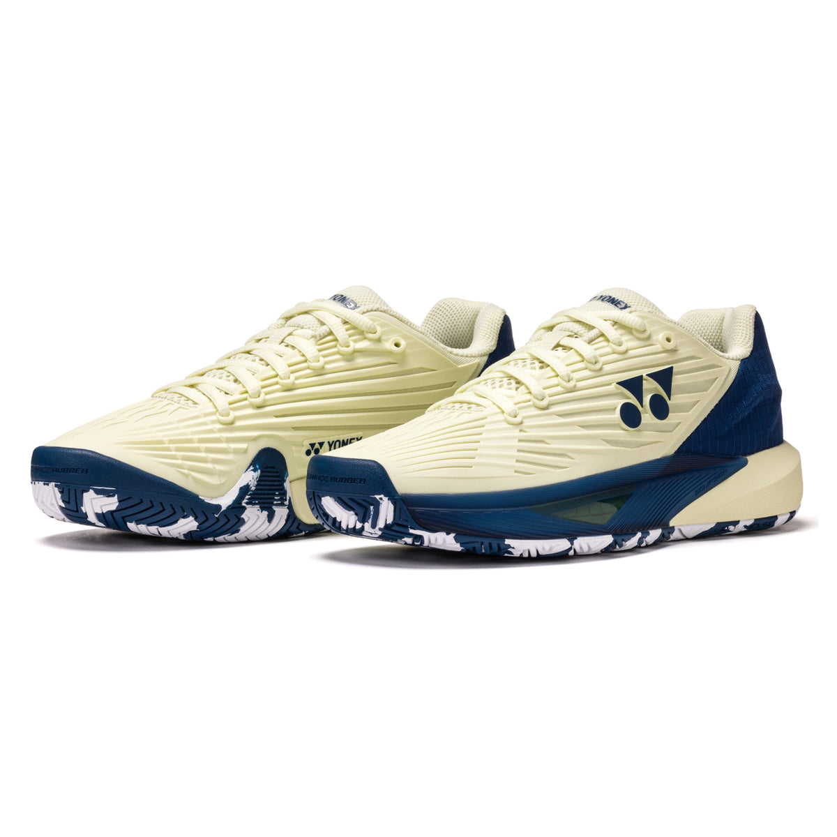 Pair of cream and navy tennis shoes on a white background