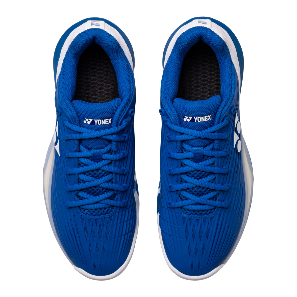 Pair of blue Yonex tennis shoe on a white background