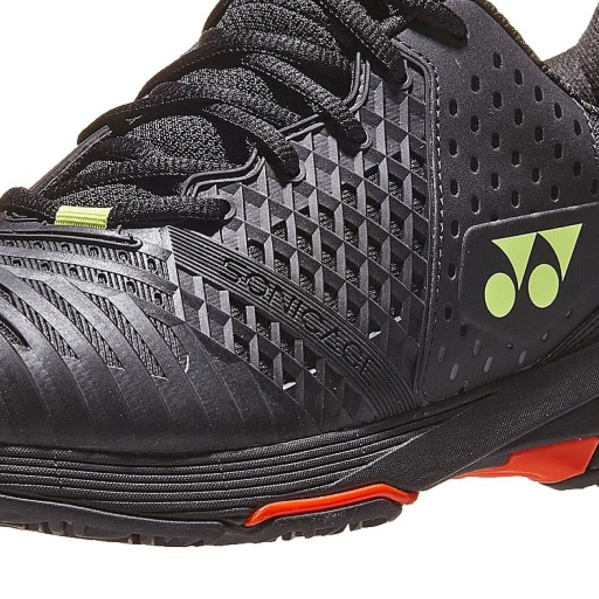 Black Yonex tennis shoe with red sole and Yonex logo on a white background