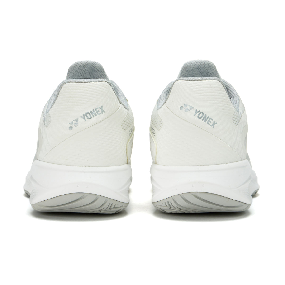 White Yonex tennis shoes shown from the back on a white background
