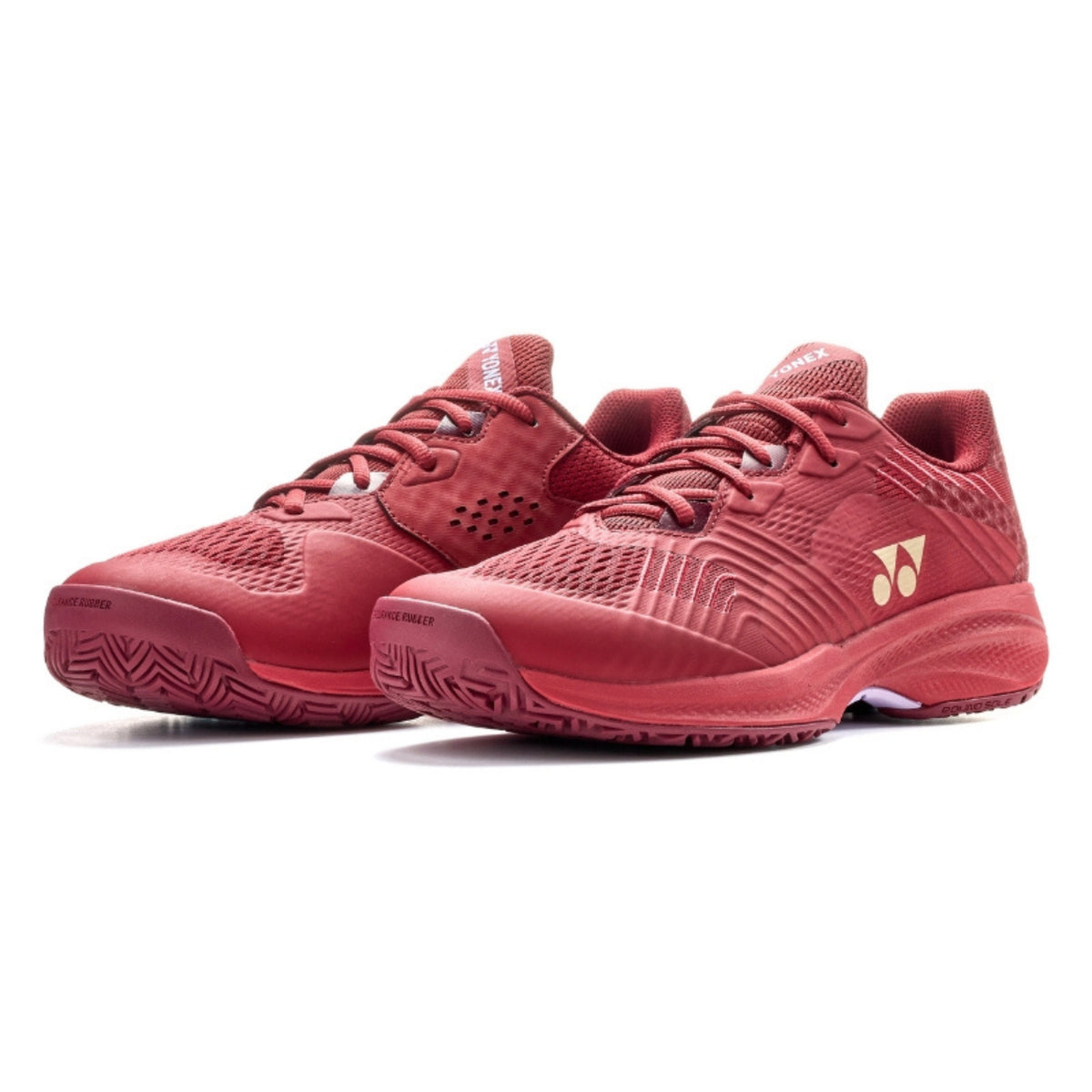 Red tennis shoes with a brand logo on a white background