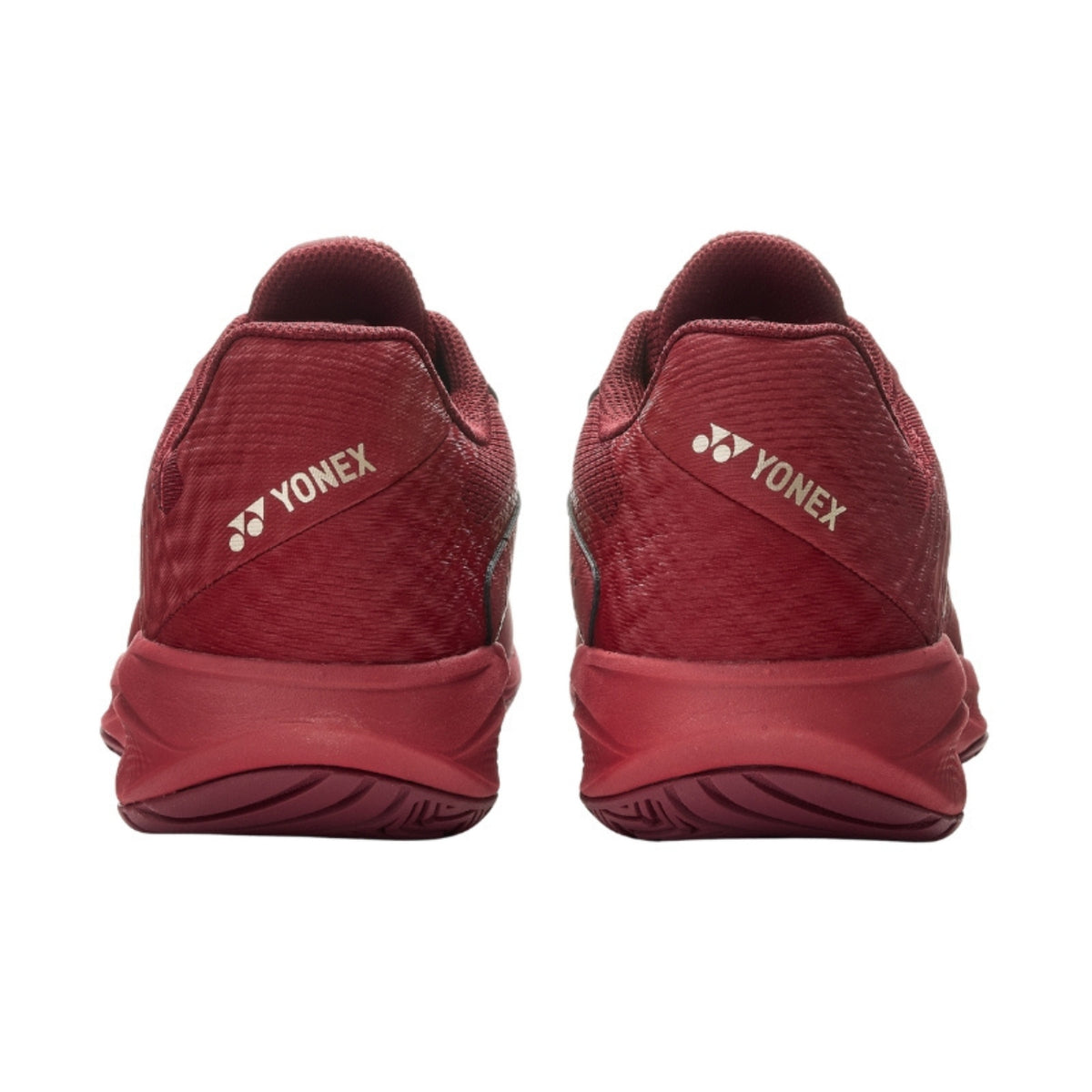 Red Yonex tennis shoes shown from the back on a white background