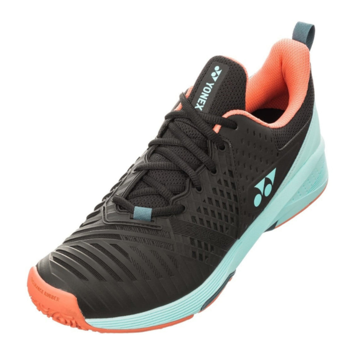 Black Yonex tennis shoe with orange and blue sole on a white background