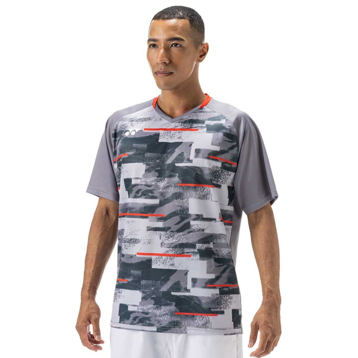 Man wearing a gray sports shirt with a geometric pattern on a white background