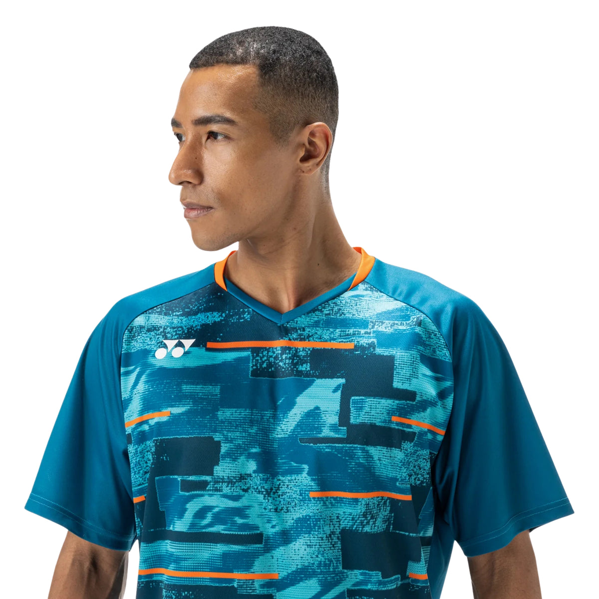 Man wearing a blue sports shirt with orange accents on a white background