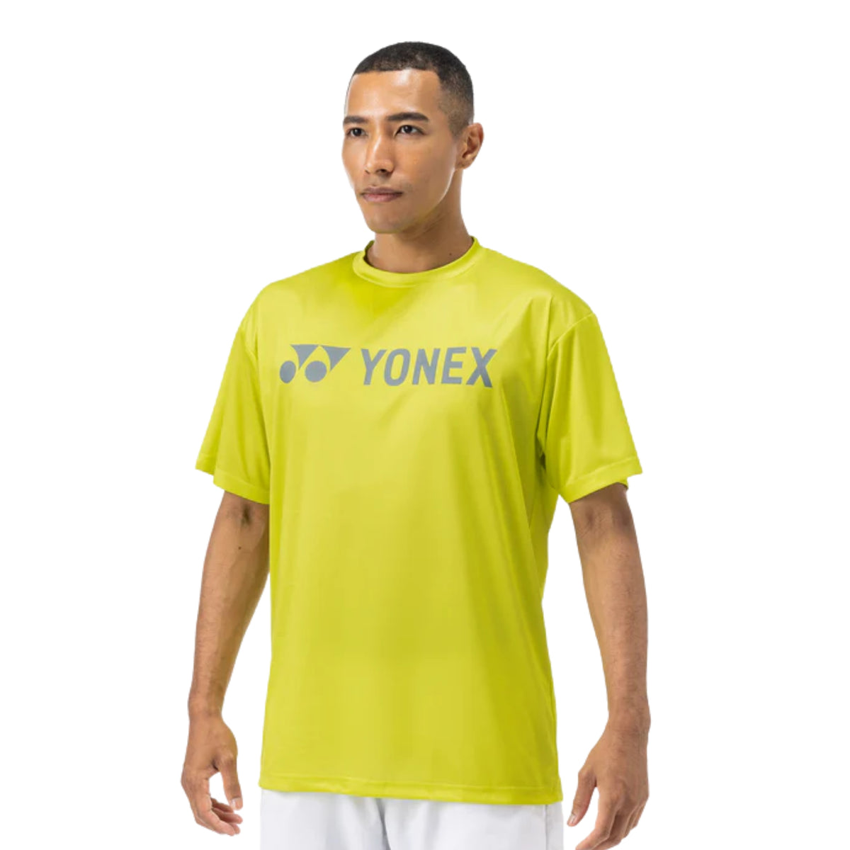 Man wearing a bright yellow Yonex shirt on a white background