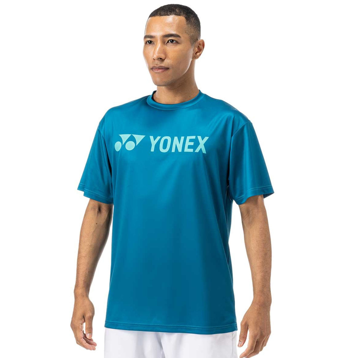 Man wearing a blue Yonex t-shirt on a white background