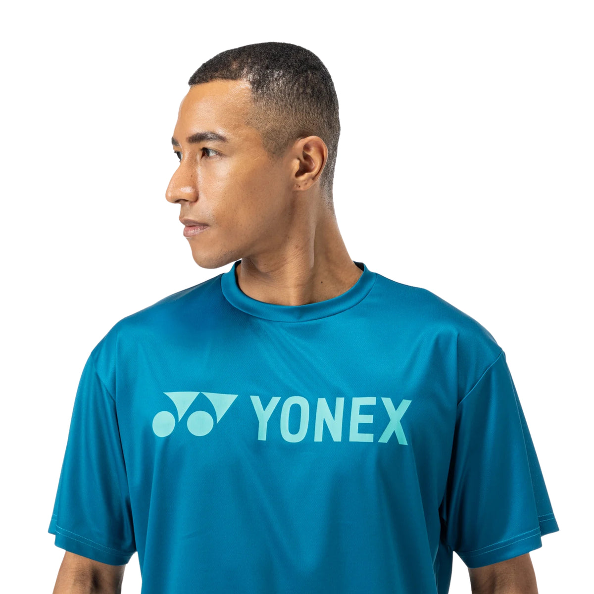 Man wearing a blue Yonex t-shirt on a white background